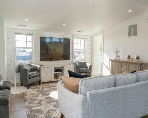 Upper story addition with grey couch and black chairs by Raymond Design Builders in Fairfield County, Connecticut