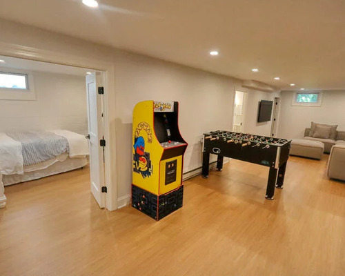 basement with bedroom and hardwood floors by Raymond Design Builders in Fairfield County, Connecticut