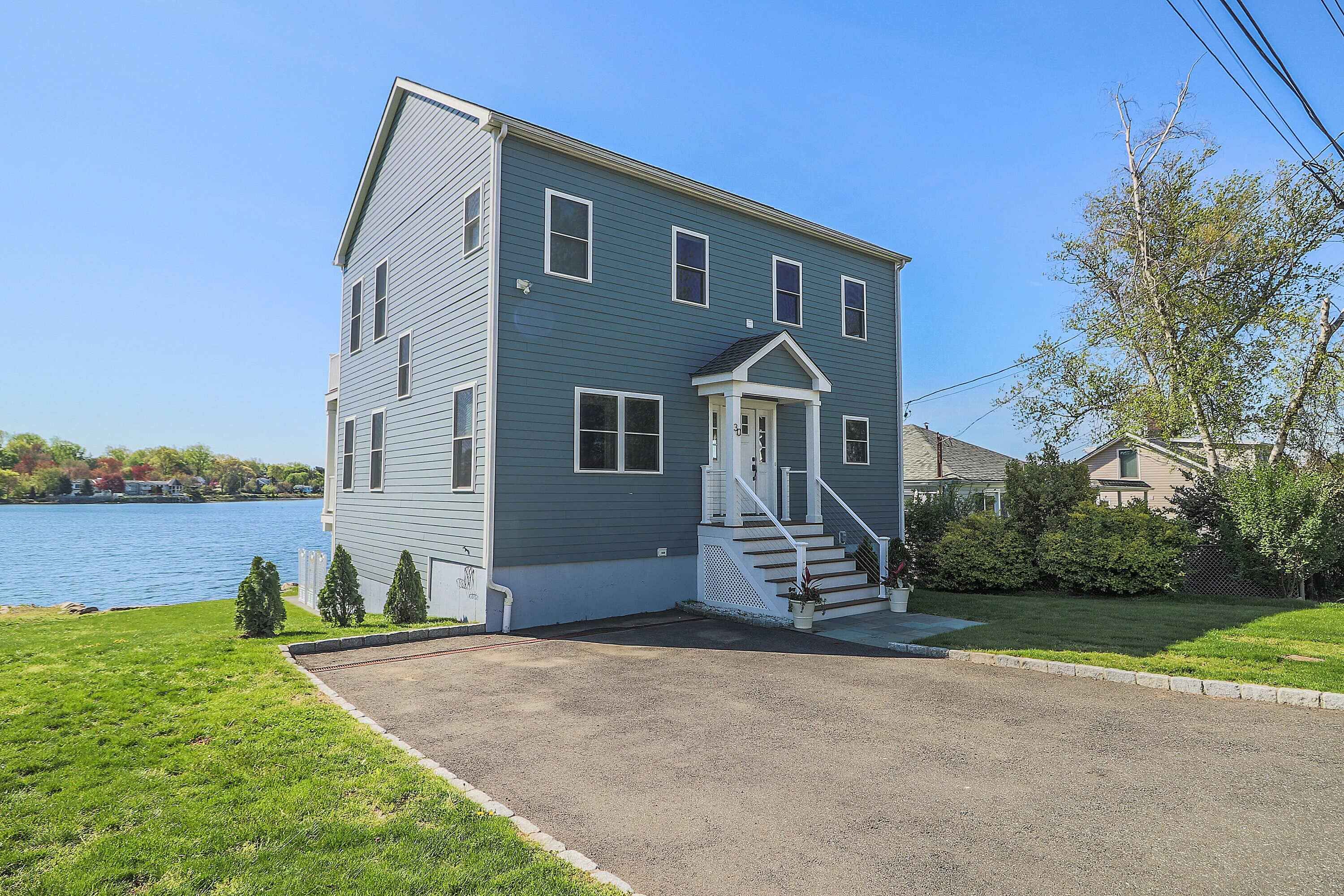 exterior of custom home on the water by Raymond Design Builders in Fairfield County, CT