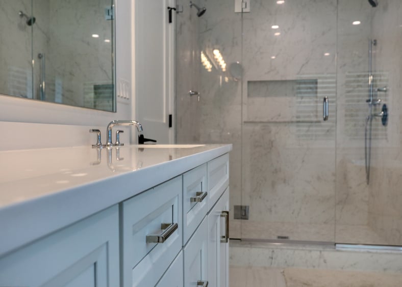 close up shot of remodeled bathroom sink and walk in shower by Raymond Design Builders in Fairfield County, CT