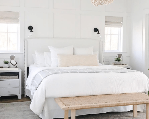 Light Color Scheme Bedroom with queen bed and wainscotting walls by Raymond Design Builders in Fairfield County, Connecticut