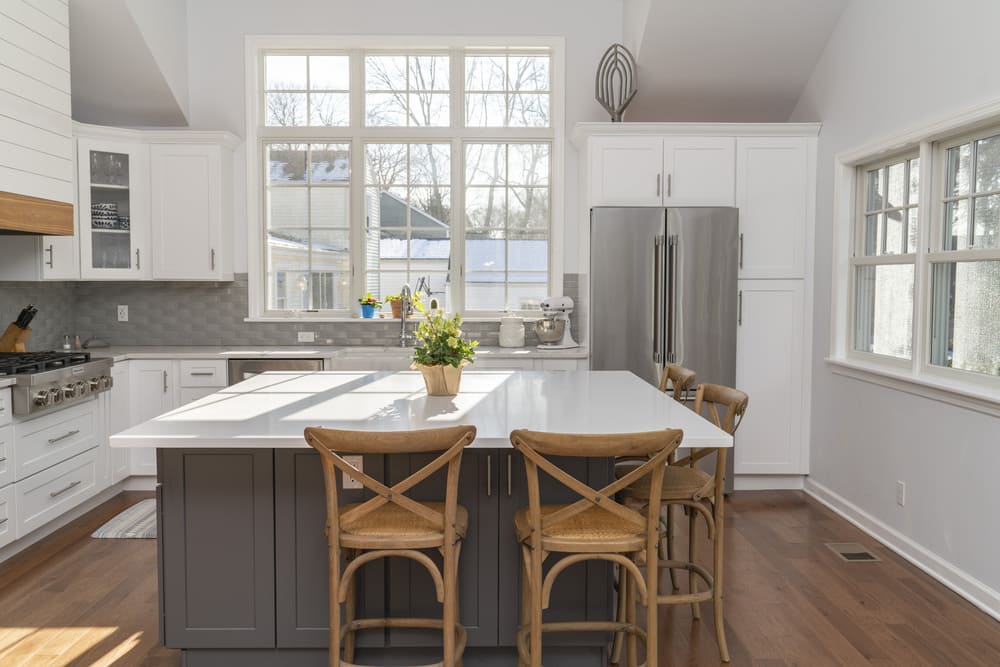 close up of white kitchen island with brown bar chairs in fairfield