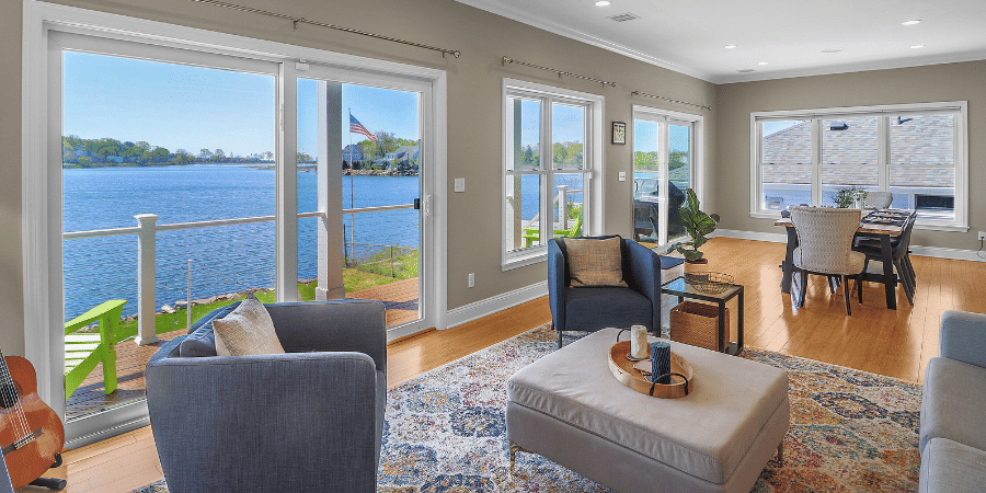 stunning open floor living room and dining room on the water by Raymond Design Builders