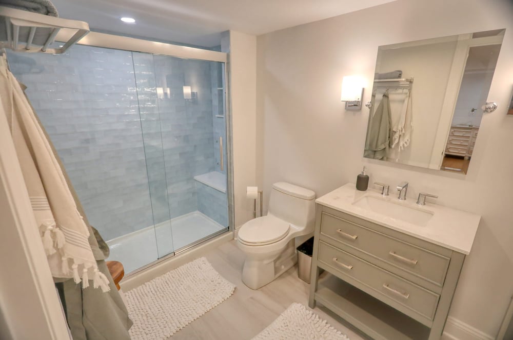 white modern farmhouse bathroom with white hardwood by raymond design builders in ct