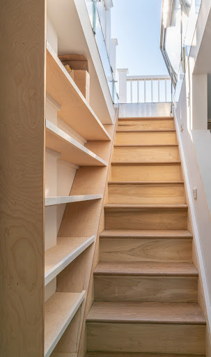 built in shelving along stairway by raymond design builders