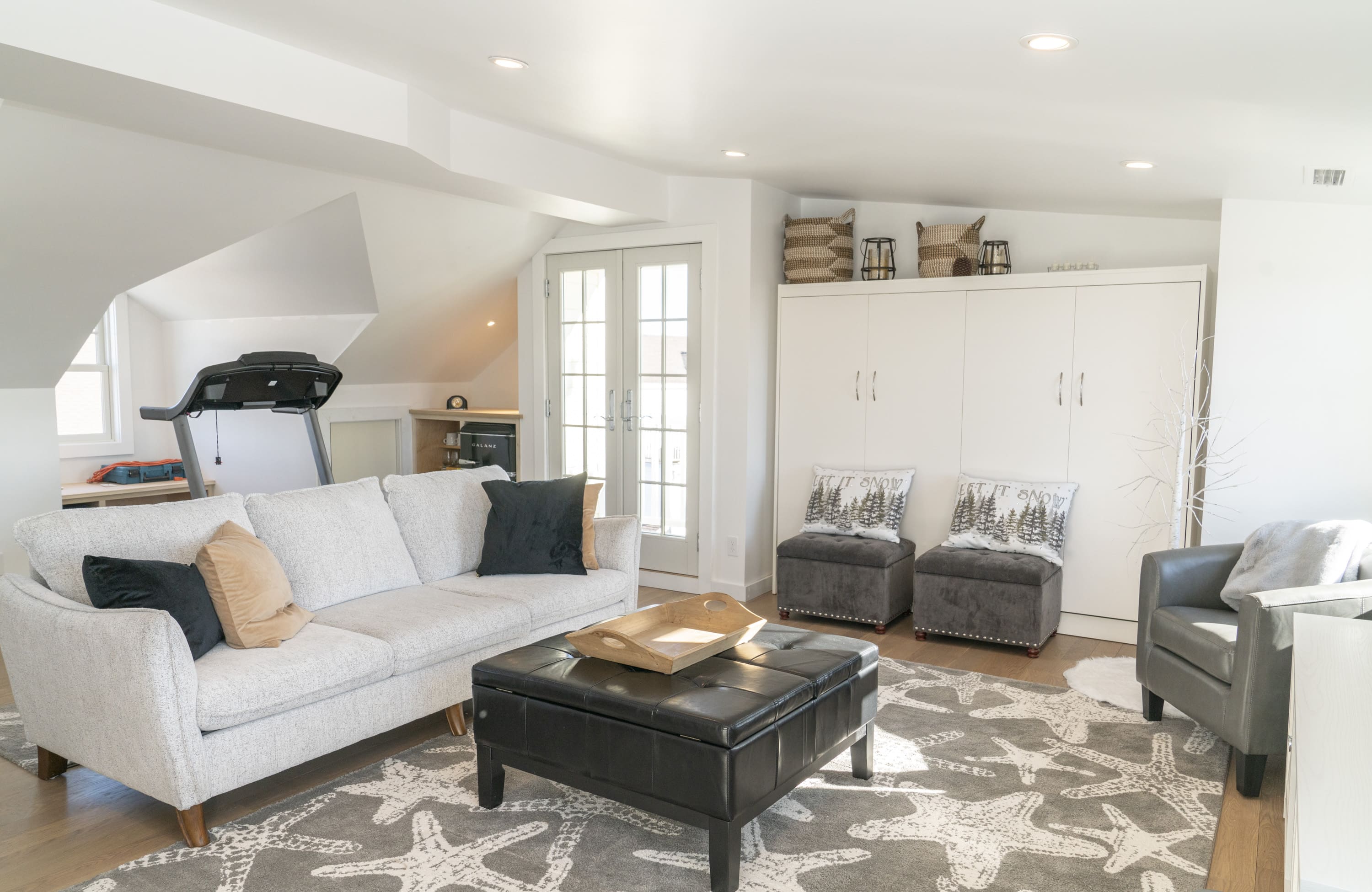 third floor living room remodel with white soft couch by raymond design builders