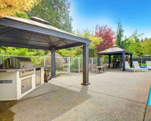 backyard cabanas with grill and chairs for outdoor gathering