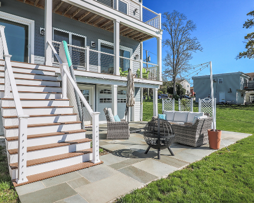 backyard patio with large round firepit in Fairf