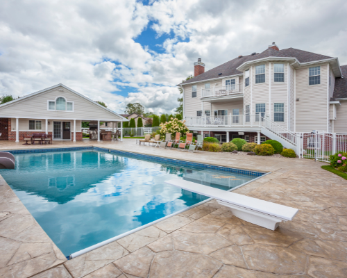 detatched pool house with large in ground pool and diving board with slide in Fairfield County, Connecticut by Raymond Design Builders