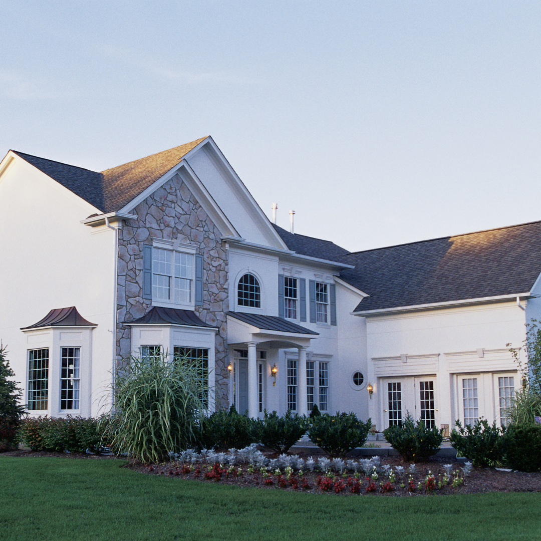 large white home with magnificent garden