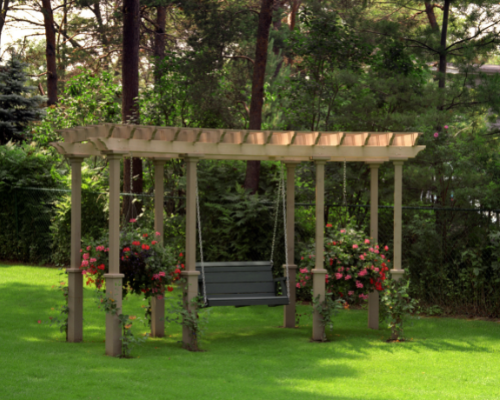 pergola with black swinging bench handing and large hanging flower pots with pink and red flowers
