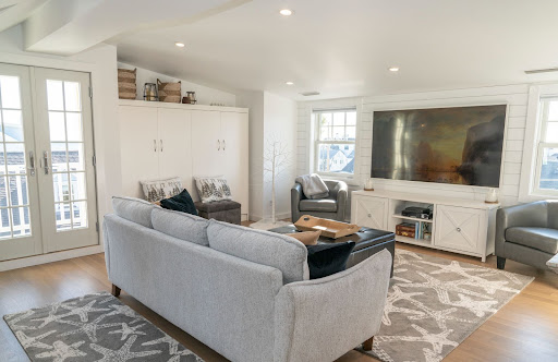 third floor living room remodel with grey couch by raymond design builders 2