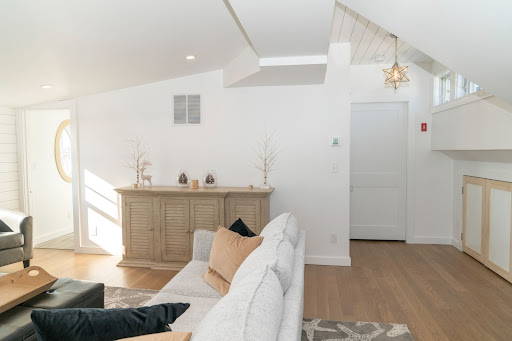 third floor living room remodel with white soft couch by raymond design builders 2