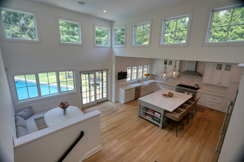 white kitchen arial view with large breakfast nook by raymond design builders in ct