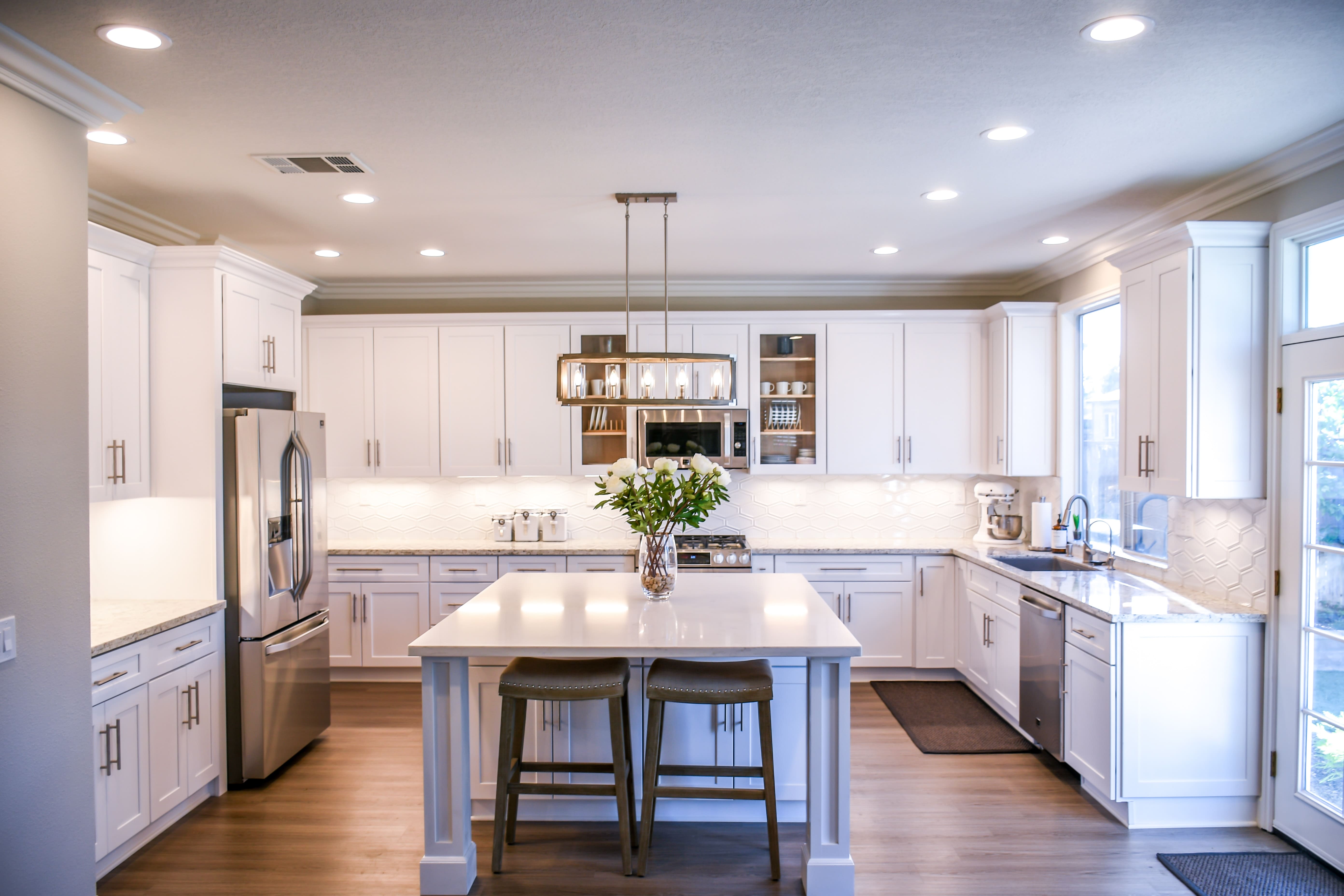 white kitchen with geometric light fixture