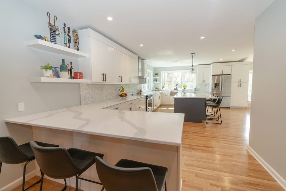 hanford drive kitchen with white corner bar area by raymond design builders in ct