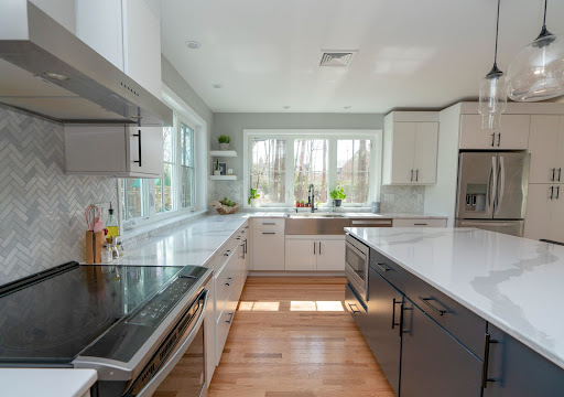 kitchen electric stove with white countertop by raymond design builders