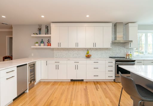 white cabinets in bright kitchen by raymond design builders