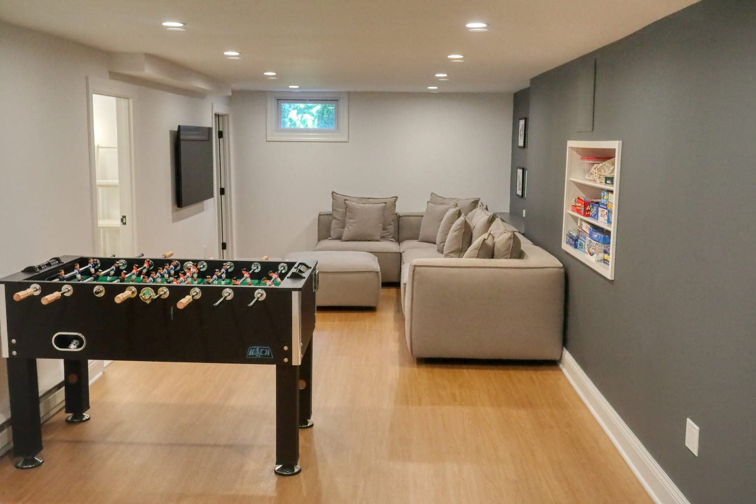 basement game room with large foosball table by raymond design builders in ct