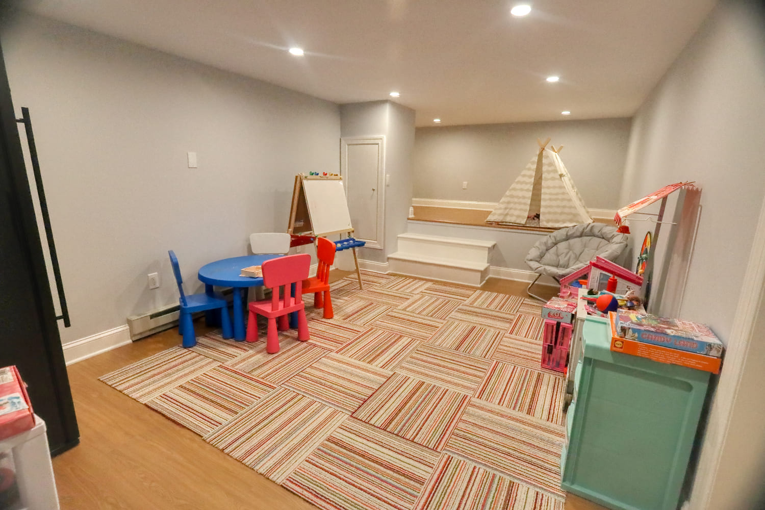 colorful childrens play  room with hardwood by raymond design builders in ct