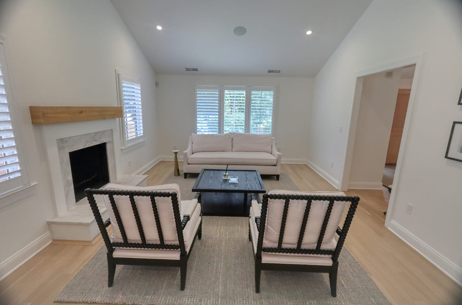 modern farmhouse style living room with white chairs and black accents by raymond design builders in ct