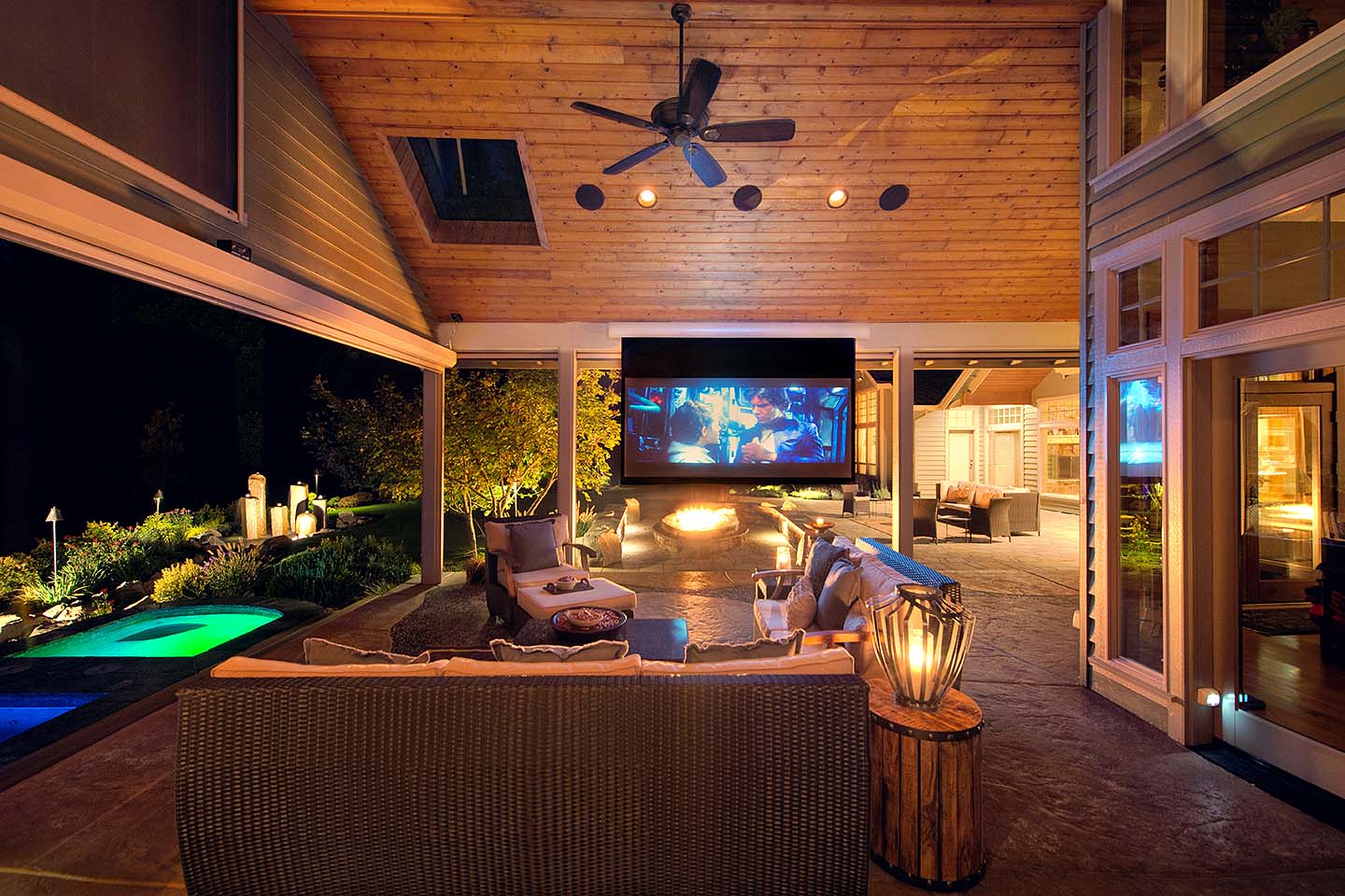 beautiful rustic outdoor living area with projector and wood roofing