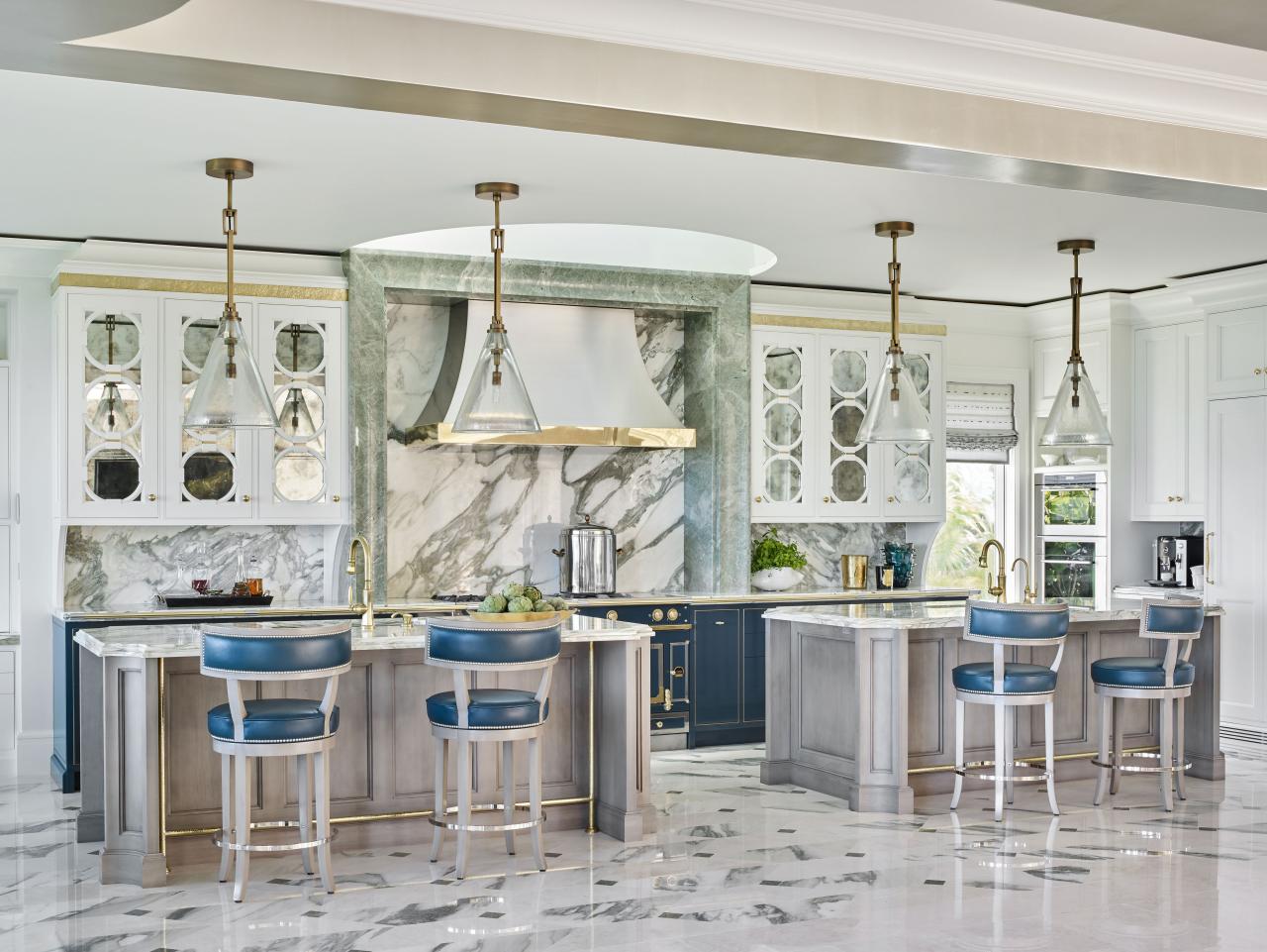 luxury marble designed kitchen with gold accents highlighting the faucets and counters